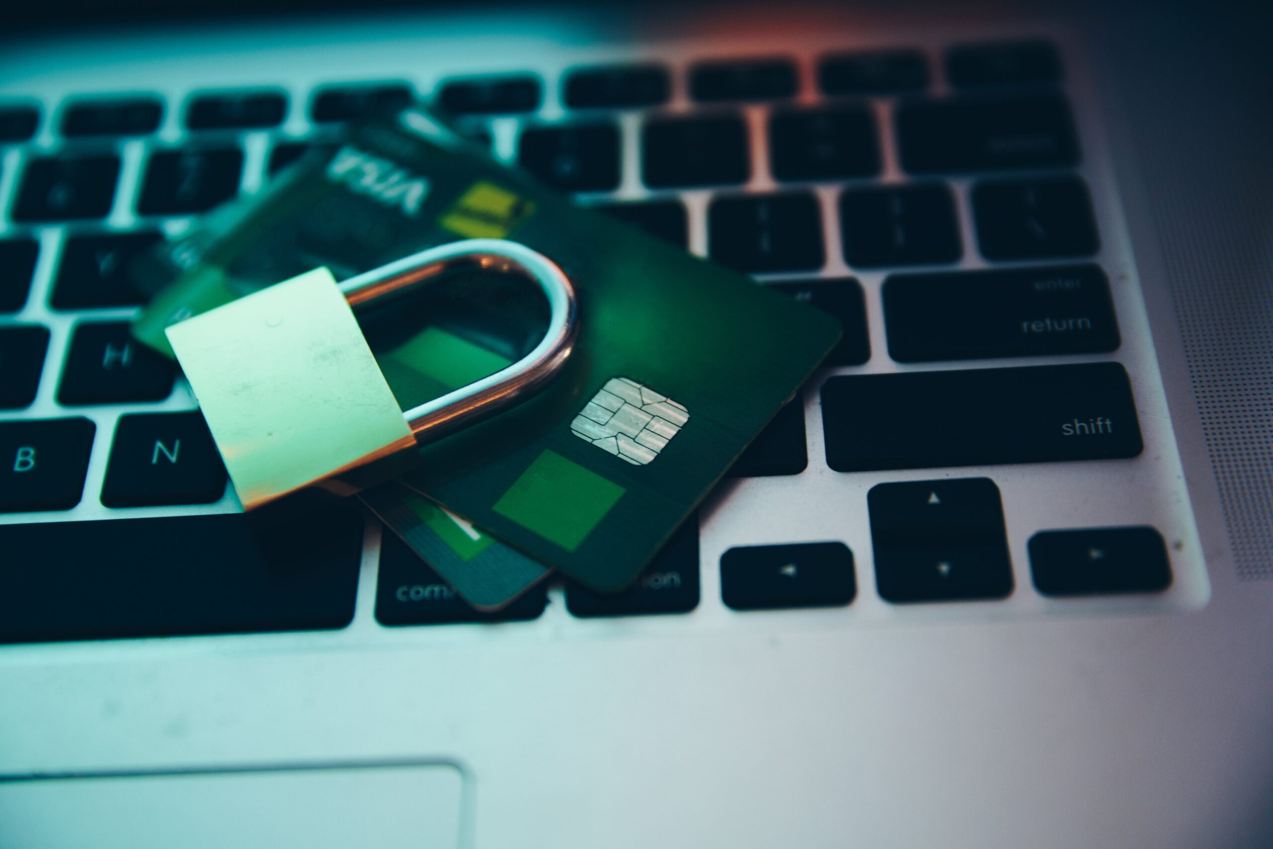Image of lock and credit card on laptop keyboard to represent catfishing in ecommerce