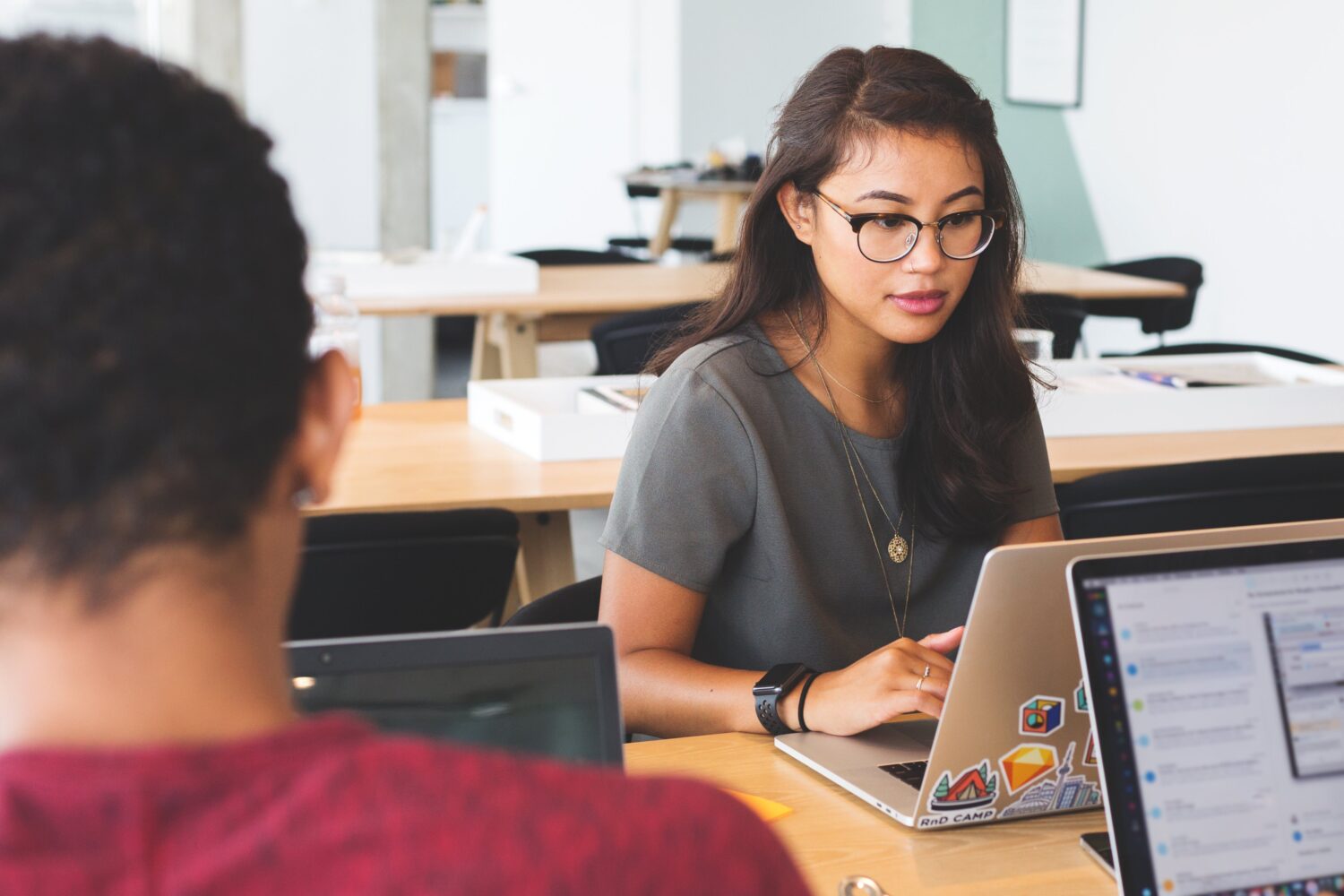 woman at laptop working in fraud prevention customer experience