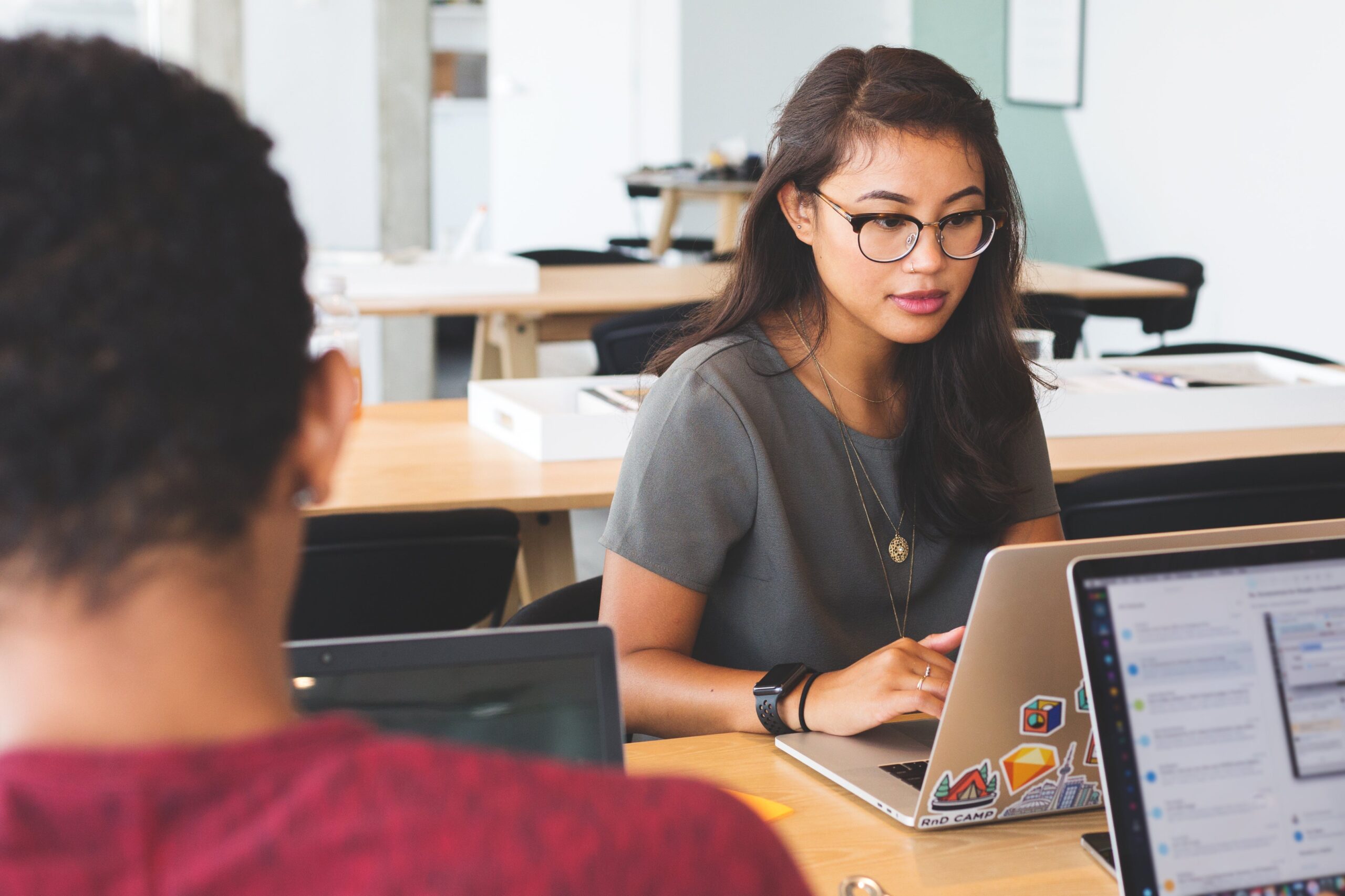 woman at laptop working in fraud prevention customer experience