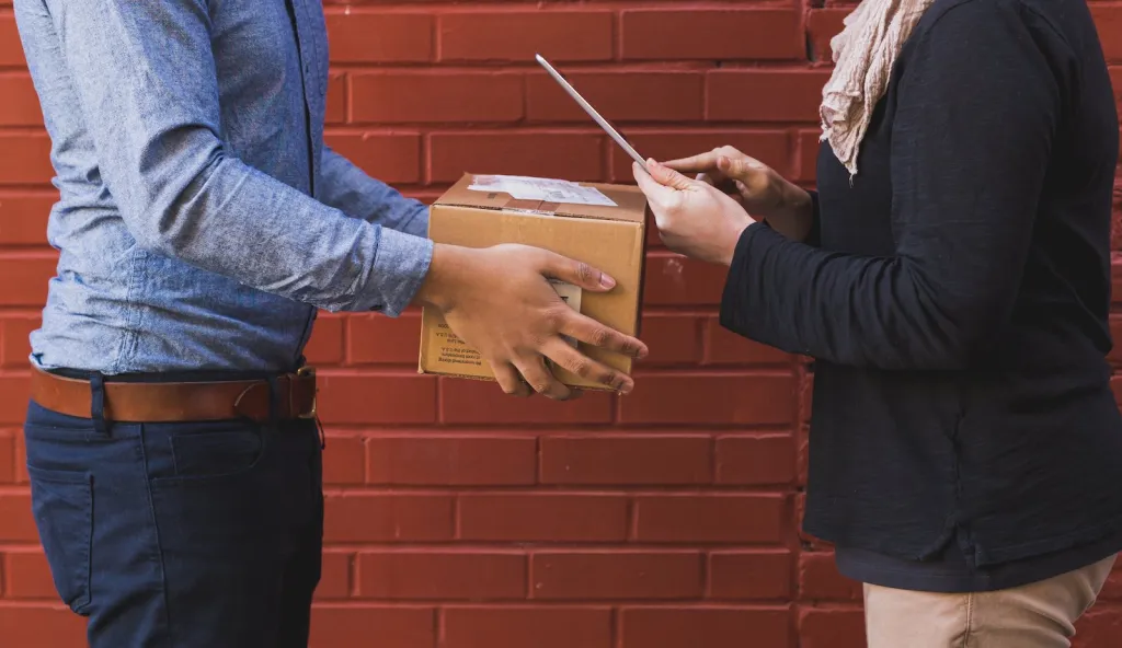 A Man Delivering a Parcel at Its Destination